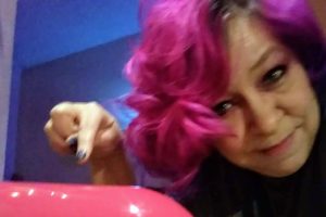 Bright Pink Kitchenaid Mixer with Dix pointing at it.