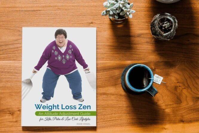 Weight Loss Zen book mockup – low carb attitude adjustment guide for keto, paleo, and carb-conscious eaters, shown with coffee and plants on a wooden table.